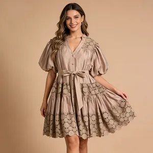 Detailed view of French style puff sleeve dress with floral lace trim and waist tie