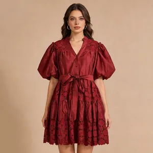 Front view of a French style burgundy short dress with puff sleeves and floral lace hem