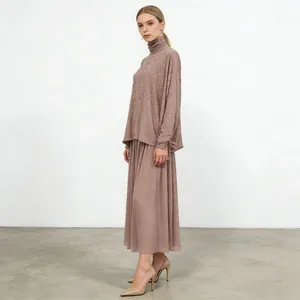 Full view of elegant mauve two-piece set with rhinestone turtleneck top and A-line skirt