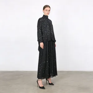 Full view of black rhinestone high-neck long-sleeve top and A-line skirt two-piece set