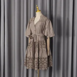 Detail view of French style V-neck dress with lace hollow-out design and puff sleeves