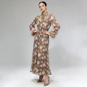 Full view of elegant lace embroidery dress with feather cuffs and pearl details