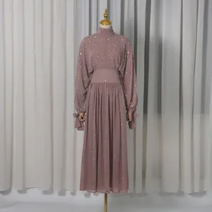 Mauve two-piece dress set with sequin embellishments displayed on a clothing mannequin.