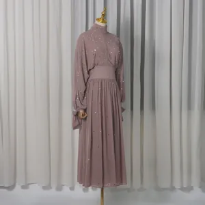 Detail of the elegant mauve two-piece set featuring a high neck top and sequined skirt