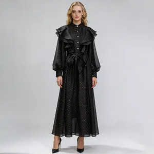 Full-length detail of a vintage black court style dress with ruffles and gold dots