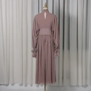 Detailed back view of a dusty rose two-piece skirt set with sparkling rhinestones
