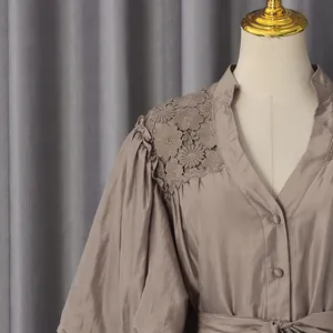 Close-up of V-neck French pastoral dress with intricate crochet floral lace on shoulder