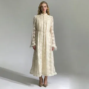 Full body view of an elegant lace embroidery dress with pearl buttons and feather cuffs.