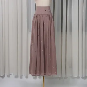 Detailed shot of an elegant mauve A-line maxi skirt with subtle rhinestone sparkle.