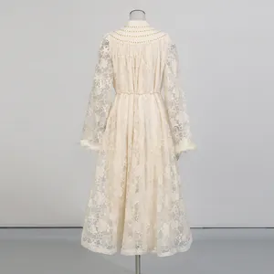 Back view detail of elegant cream lace maxi dress with feather cuffs and high collar