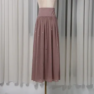 Close-up detail of a dusty rose A-line maxi skirt with sparkling rhinestone accents