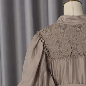 Detail view of a French pastoral dress with intricate floral lace and puff sleeves.