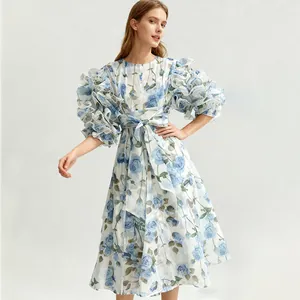 Detailed view of a vintage romantic blue rose print dress with layered puff sleeves.