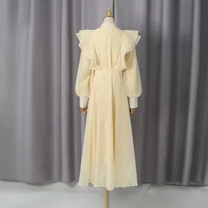 Elegant pale yellow vintage maxi dress with ruffle detailing, stand collar and waist tie