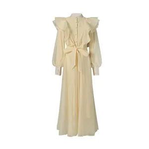 Elegant pale yellow vintage dress with ruffles, stand collar and waist tie detail.