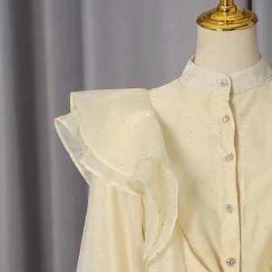 Close-up detail of vintage ruffle collar dress with sparkling sequins and crystal buttons