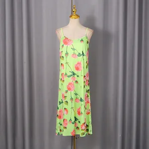 Detail view of a lime green spaghetti strap dress with vintage pink rose floral print