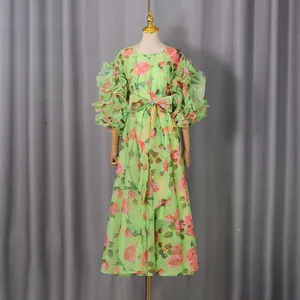 Close-up of vintage rose floral print dress featuring ruffled bubble sleeves and a waist bow