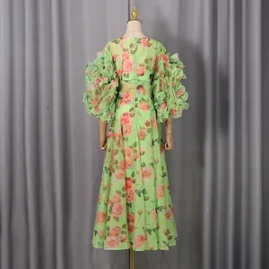 Elegant back view of a green rose print maxi dress with oversized ruffled puffy sleeves.