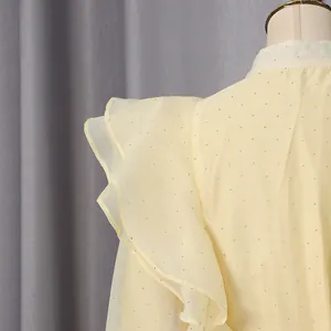 Macro view showing layered ruffles and sparkling rhinestones on vintage yellow dress