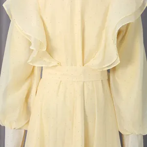 Detailed macro view showing the ruffled back and silver glitter pattern of a yellow court dress