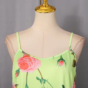 Close-up of the elegant neckline on a vintage rose print dress with green base and pink flowers