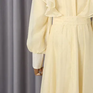 Close-up detail of romantic vintage dress with ruffles and shimmering dots pattern