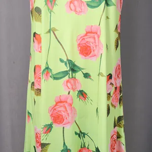 Close-up detail of vibrant lime green fabric with romantic pink rose floral print