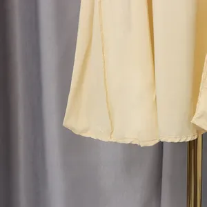 Close-up detail of the hemline and stitching on a romantic yellow vintage palace dress