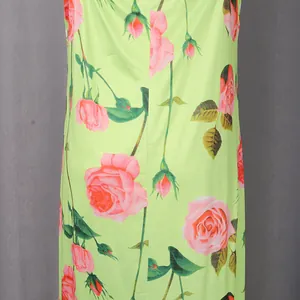 Close-up detail of romantic pink rose floral print on a light green retro dress fabric