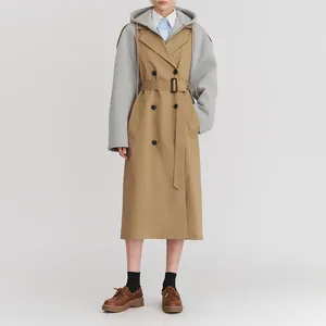 Detail eines mittellangen Damen-Trenchcoats mit grauen Kontrastärmeln und Gürtel.
