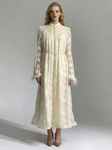 Elegant ivory lace embroidered maxi dress with pearl buttons and chic feather cuffs