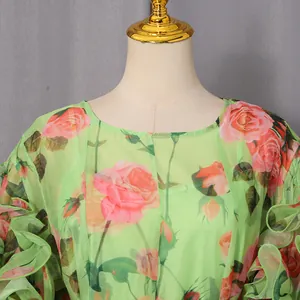 Detail shot of vintage rose print dress with elegant round neck and ruffled sleeves