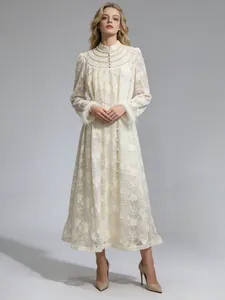 Elegant cream lace maxi dress with pearl embellishments and feather cuffs on model