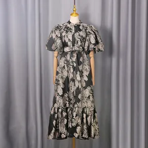 Detail view of French vintage floral puff sleeve dress with tie-waist and ruffled hem.