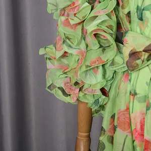 Detailed view of the romantic rose print fabric and elegant ruffled sleeves on this dress