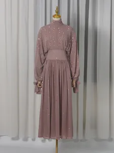 Elegant dusty pink two-piece set featuring a high-neck rhinestone top and a long A-line skirt