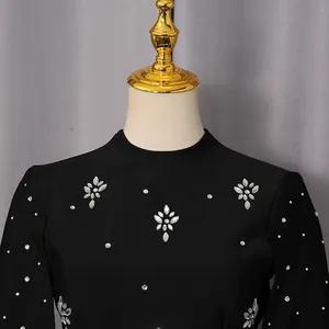Detalle de cerca de los exquisitos adornos de flores de strass brillantes en un vestido negro