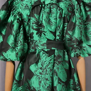Macro view of French retro floral dress detail with puff sleeves and black waist belt