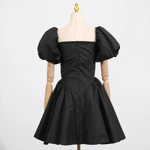 Back view of a French style black short dress with puff sleeves and high waist