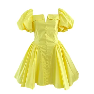 Front view of a yellow French style mini dress with puff sleeves and button-down detail