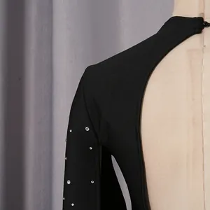 Primer plano de elegante vestido de noche negro sin espalda con detalles de pedrería