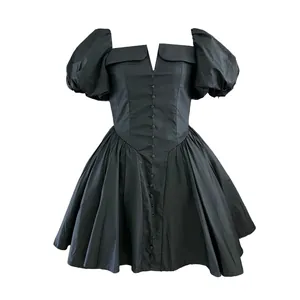 Detail view of a black French elegant dress with puff sleeves and cinched waist