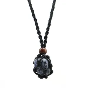 Close-up of a blue natural stone pendant encased in a black hand-woven mesh bag