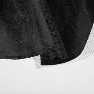 Detailed close-up showing delicate black mesh layers on an elegant French style dress.