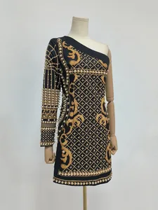 Exquisite visual detail of a one-shoulder vintage dress with pearl and gold baroque prints