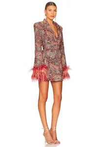 Model wearing a V-neck floral mini dress with elegant feather trim on the cuffs