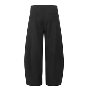 Back view of black curved-leg retro trousers with 3D pleated cut for a loose fit