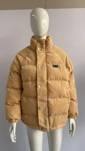 Detail shot of a winter beige corduroy puffer jacket for men on a white mannequin