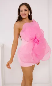Detail of a pink one-shoulder dress with a giant organza flower for parties.
